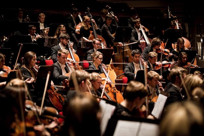 String players performing in an orchestra